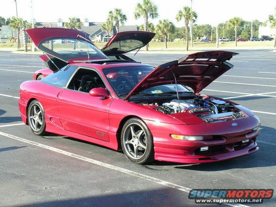 Red 1993 Ford Probe with hood and butterfly doors open