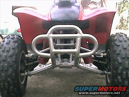 Front view of a red Honda ATV with a silver bumper and large tires