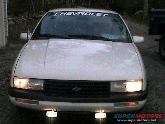 White 1992 Chevrolet Corsica sedan, front view, with 'CHEVROLET' banner on windshield