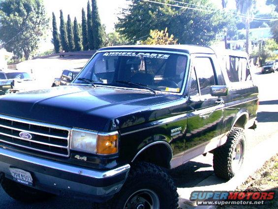 1989 Ford Bronco parked on a street, 3/4 front view. "4x4" badge visible on front fender