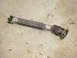 1989 Ford Bronco - A driveshaft with visible universal joints and a welded extension lies on the ground.