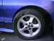 1993 Ford Probe - A close-up view of the front wheel and fender of a blue 1993 Ford Probe.