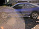 1993 Ford Probe - The side of a blue coupe shows damage to the lower body panels and some visible rust.