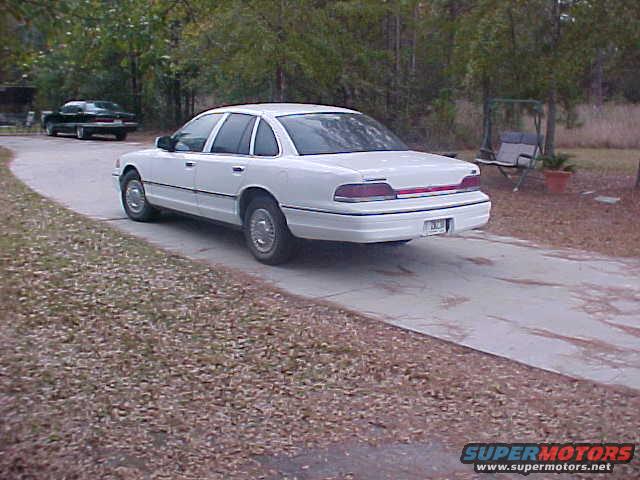1993 Ford Crown Victoria parked on a driveway, with another dark sedan in the background