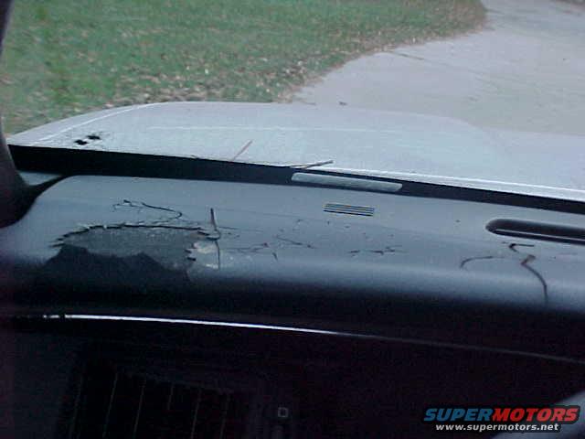 dashboard with cracked vinyl and hood of a car