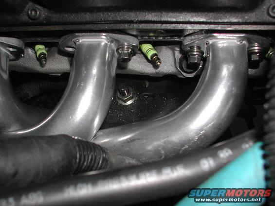 Engine exhaust manifold with spark plugs visible