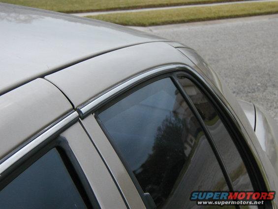 1999 Ford Crown Victoria side view, showing roofline and window trim
