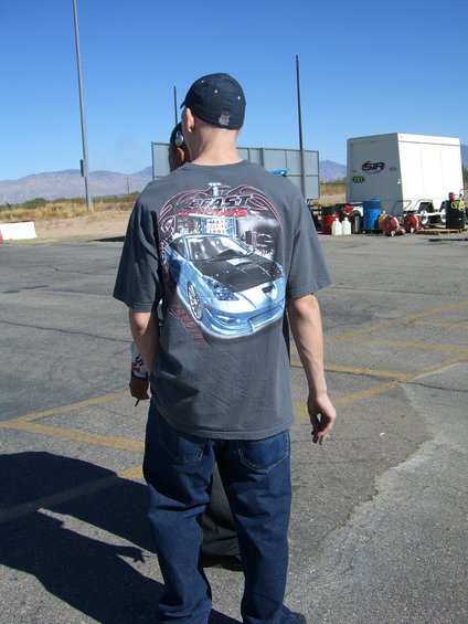 Guy wearing a t-shirt with a blue car graphic on it. The shirt says "FAST CARS"