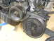 1993 Mazda MX-3 - A close-up view of an engine's pulley and compressor assembly, showing mechanical components.