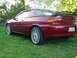 1993 Mazda MX-3 - Rear view of a red 1993 Mazda MX-3 coupe with a spoiler and aftermarket wheels.