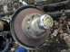 1979 Ford Bronco - A close-up of a rusty front wheel hub assembly, likely from an older vehicle, with a visible brake rotor.