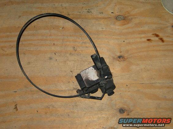Automotive part with a black cable loop attached to a black plastic housing