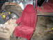 1994 Ford Bronco - The interior of a vehicle shows a detached seat, a fuel tank, and a toolbox next to a heavily damaged wheel well.
