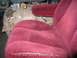 1994 Ford Bronco - Interior view of a vehicle showing red striped seats and a fuel tank.