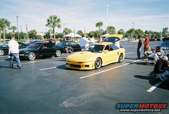 Yellow sports car with aftermarket body kit and trunk open