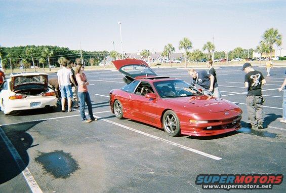 Red 1991 Ford Probe with trunk open, parked in a lot