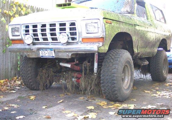 1978 Ford Bronco, mud-covered, lifted, with large tires and aftermarket grille