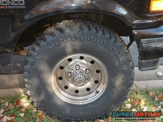 Black 1994 Ford Bronco XLT with off-road tire and chrome wheel