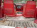 1988 Ford Bronco - The interior of this SUV features red fabric seats and a red dashboard with a factory radio and climate controls.