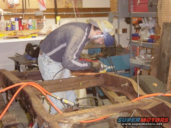 dsc00484.jpg Cleaning up around the #4 crossmember to patch the damage around those two body mounts.  In between 11/10 and this picture (11/20), we spent a LOT of time cleaning the frame, and removed the old cab mounts (including brackets where no longer needed).  I've mostly got frame rivet removal down to a 20 minute per rivet science at  this point.  No pictures in between because I was working my poor photographer half to death.