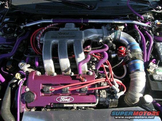 Ford V6 engine with purple hoses and valve covers, showing "Ford" badge