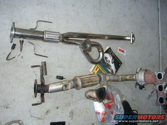 Exhaust system parts laid out, including catalytic converter and flex pipe