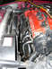 1997 Ford Probe - Close-up view of a car's engine bay, highlighting a newly installed exhaust manifold.