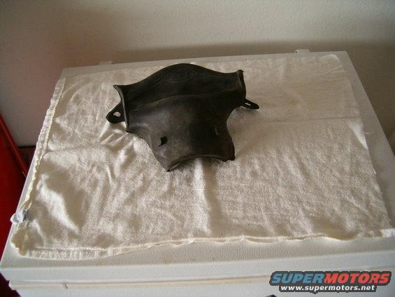 dark-colored automotive part on white cloth