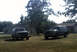 1996 Ford Bronco - Two Ford Broncos are parked on a lawn in front of houses. The Bronco on the right is a 1992 model.