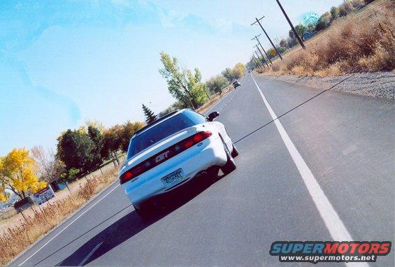 White 1996 Ford Probe GT rear view on a road