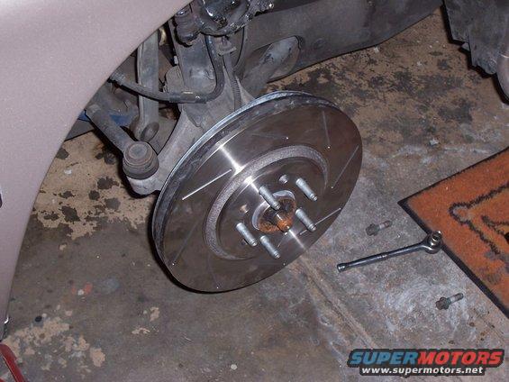 Slotted brake rotor and suspension parts on a vehicle
