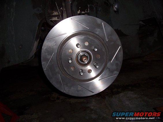Slotted brake rotor installed on a vehicle hub