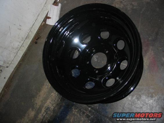 Black steel wheel with five circular cutouts