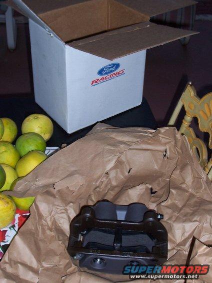 Ford Racing brake caliper in packaging with oranges and a box