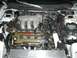 1996 Ford Probe - The engine bay of a vehicle, a Mazda engine with its cover and intake system visible.