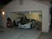 1996 Ford Probe - A white 1996 Ford Probe with black hood stripes is parked inside a garage.