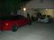 1996 Ford Probe - Two sports cars, including a 1996 Ford Probe, are parked in a garage at night.