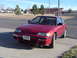 1999 Honda Prelude - A red 1988 Honda CRX is parked on a concrete surface with a building and trees in the background.