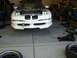 1996 Ford Probe - A white 1996 Ford Probe is parked in a garage with its hood open, revealing the engine compartment.