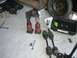 1996 Ford Probe - Car parts including drive axles and suspension assemblies are laid out on a garage floor.