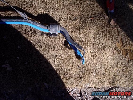 Close-up of a car's suspension part with blue and black components
