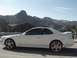 1999 Honda Prelude - Side profile of a white 1999 Honda Prelude SH coupe parked on a roadside with mountains in the background.