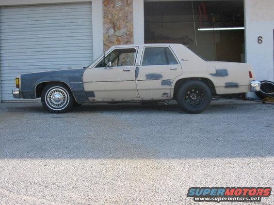 Side view of a 1985 Ford Crown Victoria LTD undergoing bodywork
