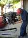 1996 Ford Probe - A V6 engine is removed from a red car with a hoist and engine crane.