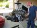 1996 Ford Probe - Engine removal or installation in progress with a person assisting.