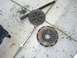 1996 Ford Probe - Car parts, a clutch disc and pressure plate, are laid out on the ground next to tools.