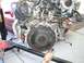 1996 Ford Probe - Engine and transmission assembly being worked on, with a portion of a red vehicle in the background.