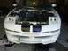 1996 Ford Probe - The front of a white coupe is shown with the hood open, revealing the engine compartment and various hoses and wires.