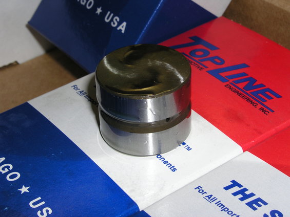 Engine lifter part on boxes labeled Top Line Engineering and Chicago USA