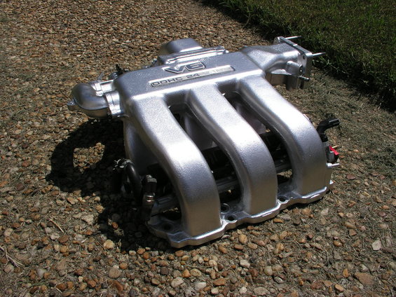 Silver V6 DOHC 24 valve intake manifold on gravel